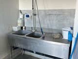 a sink with a faucet in the corner of the room
