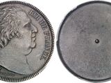 a close up of a silver coin with a face of a man