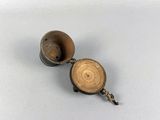 an old metal object with a wooden handle on a white surface