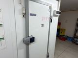 a white door in the middle of a room with a white tile floor