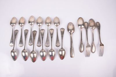 a lot of silver spoons and forks on a table