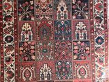 an antique persian rug with many different colors and patterns