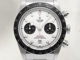 a silver watch with a black face and a white dial