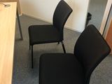 two black chairs in the corner of a room