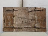 une vieille porte en bois, ouverte et posée sur une chaise