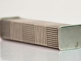 an image of a lighter that is on a white surface