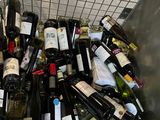 many bottles of wine sitting in a metal bin