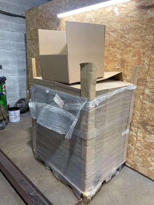 a large box sitting on top of a pallet in a garage
