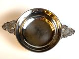 an image of a silver bowl on a white surface