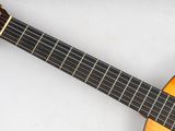 a close up of a guitar on a white surface
