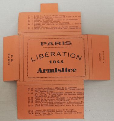 une boîte orange sur laquelle est collée une étiquette portant l'inscription « Libération de Paris »