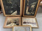 three framed paintings of a winter scene on a table in a room