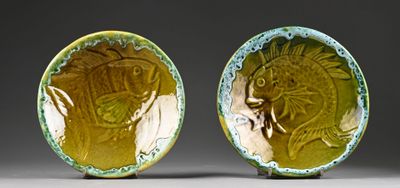 pair of yellow and green ceramic bowls with designs of a man and a woman