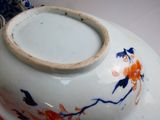 a white bowl with blue and orange designs on it