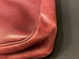 an image of a close up of a red purse on a table