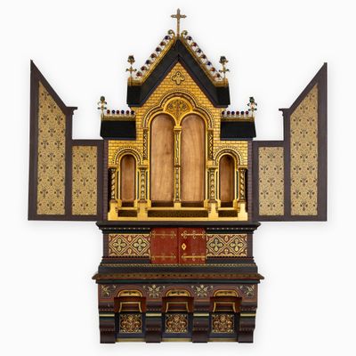 a small wooden shrine with a cross on top of it