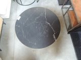 a black table with a marble top in the middle of a room