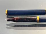 two pens sitting next to each other on a table