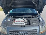 a car with its hood open and the engine in the back