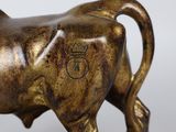 bronze statue of a bull with a crown on it ' s head