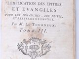 an old book with writing on it sitting on top of a table