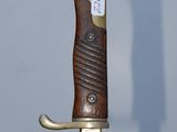a close up of a knife with a tag on it