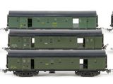 six green train cars sitting next to each other on a white surface