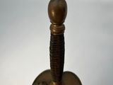 a close up of a metal object on a white surface