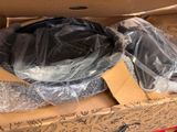 a cardboard box with a black bowl inside of it