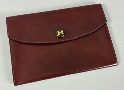 brown leather wallet with a gold clasp on the front