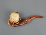 a pipe with a skull inside of it sitting on a table