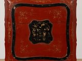 une image représentant une boîte rouge ornée d'un motif noir et or