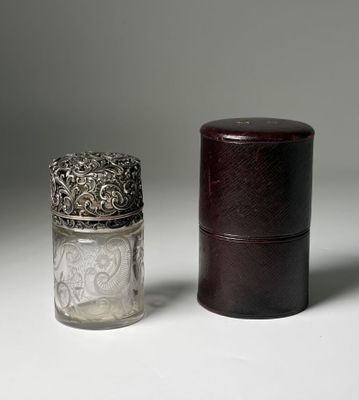 a small glass jar with a silver lid next to a small glass jar with a silver lid