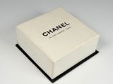 a picture of a white box with a black logo on it