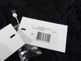a white tag with a barcode on it on a black background