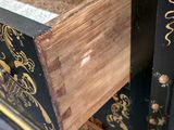 a black and gold chest with a drawer on top of it