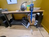 an image of a workbench in a room with a lot of clutter on it