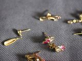 five pairs of earrings that are laying on a table