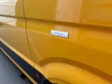 a yellow van with a sticker on the side of it