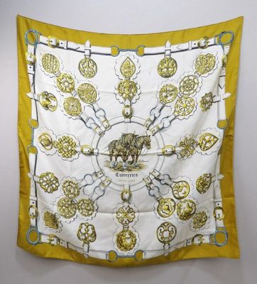 a close up of a yellow and white scarf hanging on a wall