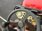 steering wheel of a red and black vehicle with a red box on top of it