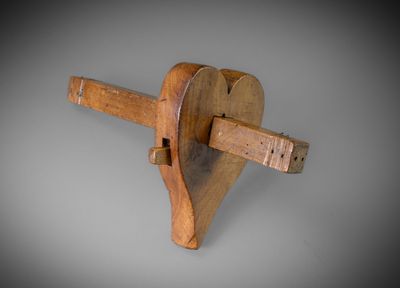 an image of a wooden object with a wooden handle on a gray background