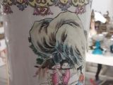 a vase that has a picture of a woman on it