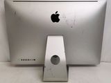 a silver apple computer sitting on a white surface