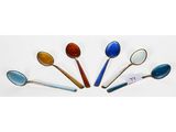 several spoons are arranged in a circle on a white surface