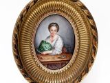an old picture of a woman sitting at a table with a cabbage in her lap