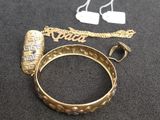 a close up of a gold ring with a chain around it