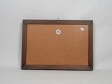 a brown cork board with a wooden frame hanging on a wall