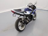 a blue and white motorcycle parked in a room