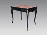 une table noire avec un plateau rouge et des détails dorés